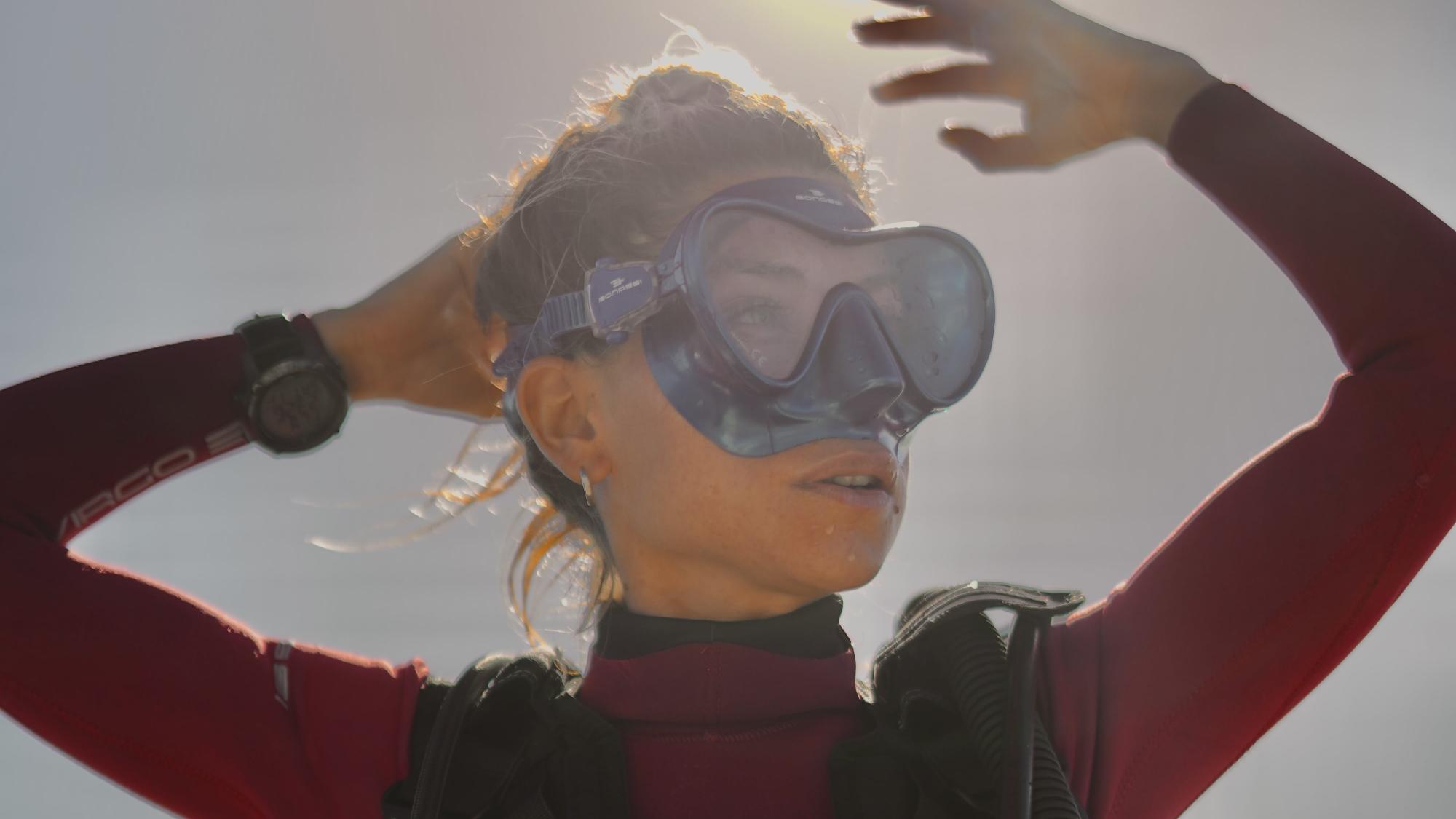 PADI AmbassaDiver Luciana Maldonado posing outside in her scuba diving gear.